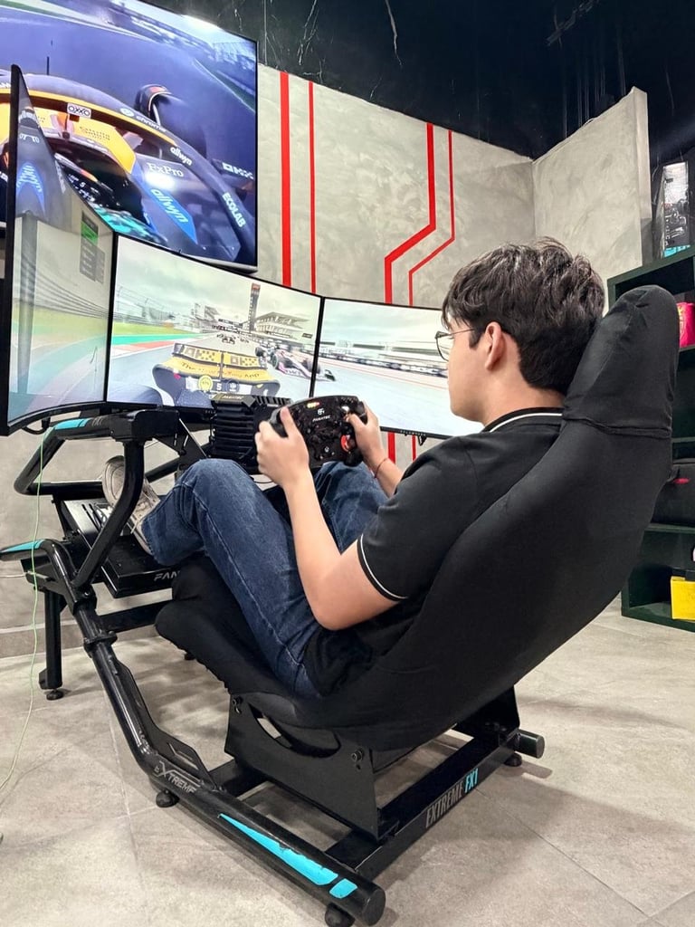 Person sitting in racing simulator seat holding controller, playing racing game on multiple screens with red and white graphics